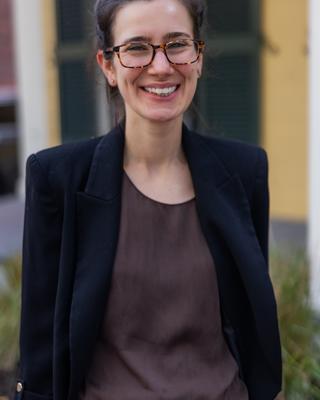 A professional headshot of Junior Fellow Emma Adler