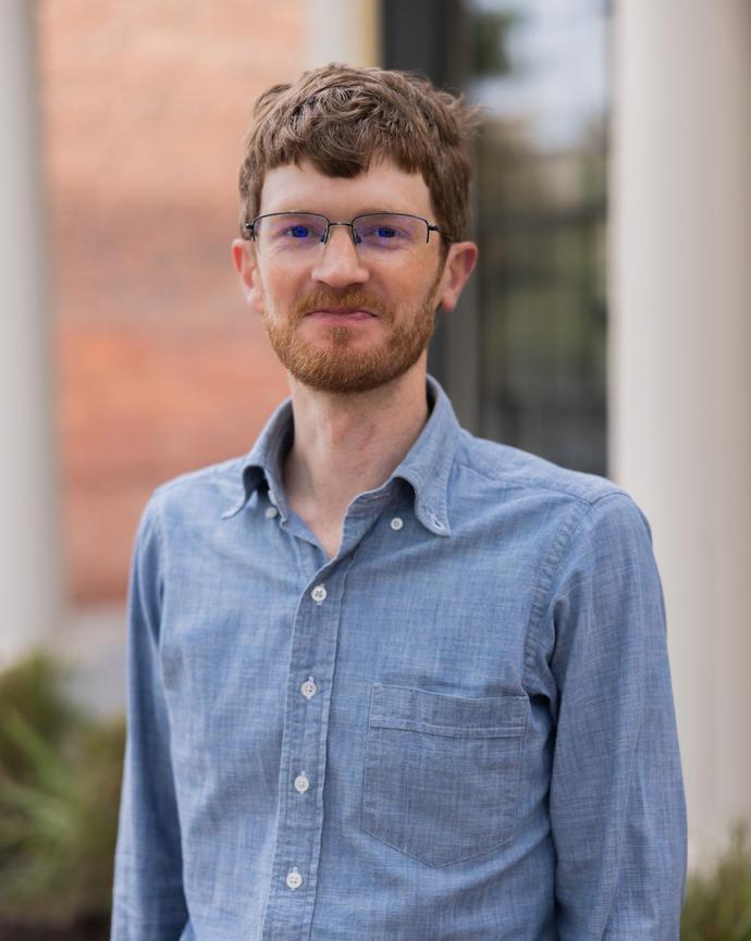 A professional headshot of Junior Fellow Alex Walton